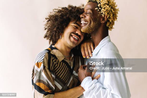 Cheerful Gay Couple Embracing Each Other In A Studio Stock Photo - Download Image Now
