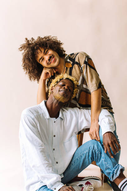 istock Happy gay couple posing in a studio 1337218242