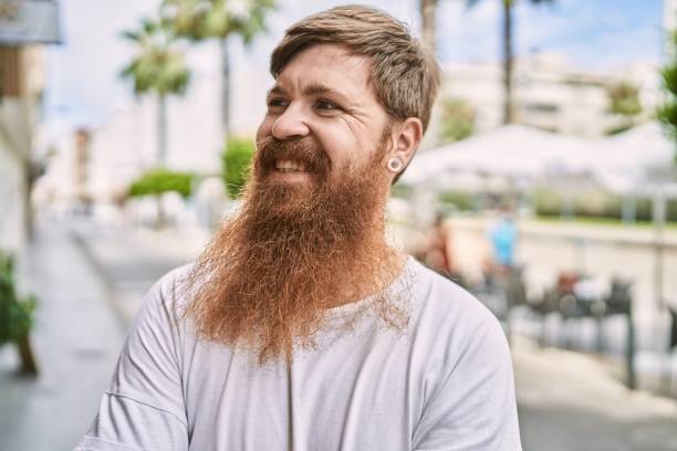 istock Young redhead man smiling happy standing at the city. 1337220816