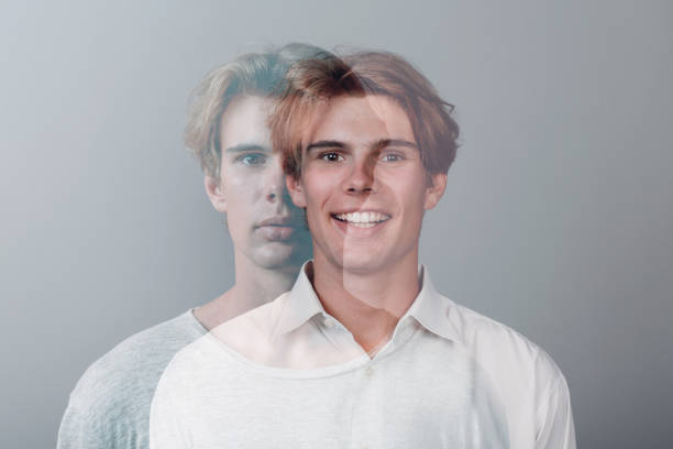 Multiple exposure portrait of young european caucasian man with positive smile and serious sad facial expression. Mental health, depression and emotions concept. stock photo