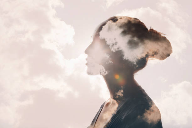 Psychology concept. Sunrise and woman silhouette head Psychology and woman mental health concept. Multiple exposure clouds and sun on female head silhouette. silence stock pictures, royalty-free photos & images