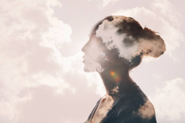 Psychology concept. Sunrise and woman silhouette head Psychology and woman mental health concept. Multiple exposure clouds and sun on female head silhouette. contemplation stock pictures, royalty-free photos & images