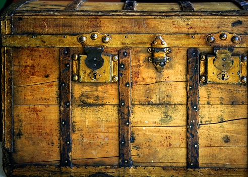 Old wooden chest, trunk in golden color and rusty