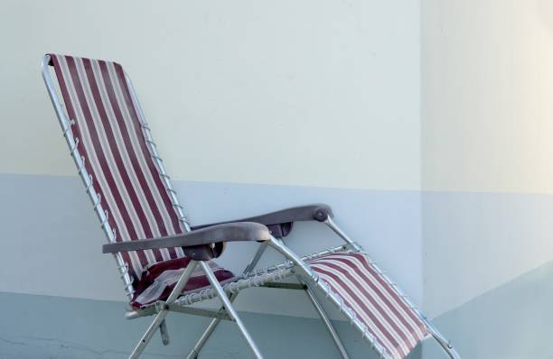 istock Alone summer chair over blue wall background 1337224367