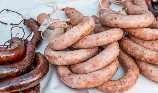 Typical Spanish sausages lying on a village stall at the food market, traditional meat products