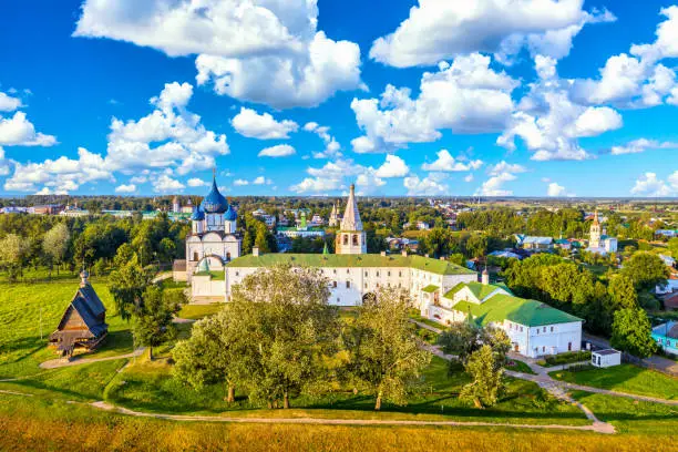 Aerial drone view of wooden Church of St. Nicholas with Kremlin in Suzdal, Russia. Summer sunny day.