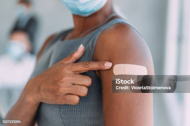 Businesswoman Showing Her Arm After Getting Vaccinated In The Office Stock Photo - Download Image Now