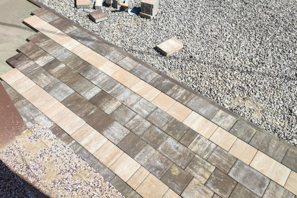 istock laying paving stones on the pavement with tools. stone block sidewalk. Road paving, construction 1337231689
