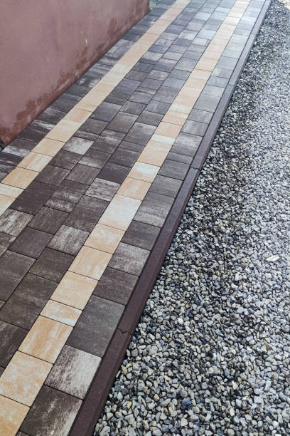istock laying paving stones on the pavement with tools. stone block sidewalk. Road paving, construction 1337232895