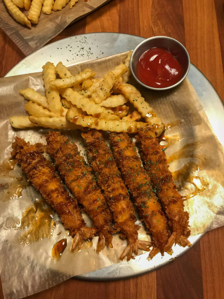 istock Fried shrimp sticks with fries 1337233926
