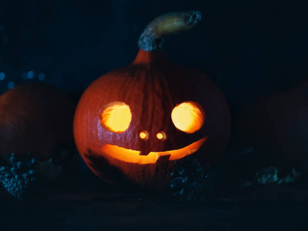 istock Creepy carved glowing pumpkin lantern in the dark 1337234420