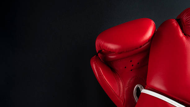 istock red boxing gloves on a black background. boxer gloves on dark background 1337235774