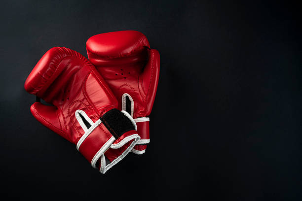 istock red boxing gloves on a black background. boxer gloves on dark background 1337235849