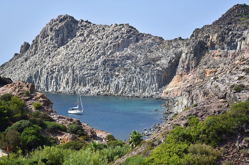 Sailing boat in an idyllic bay at isola san pietro