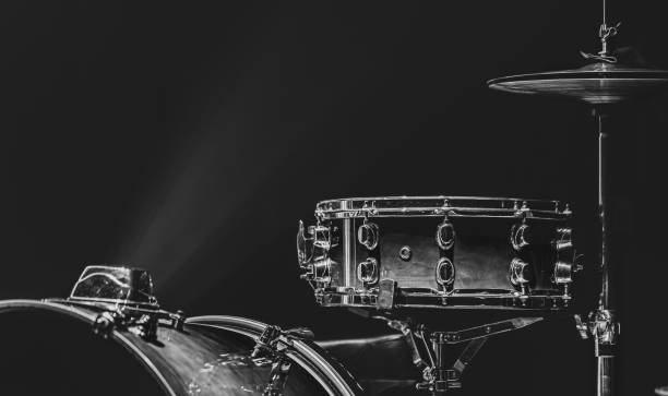 Part of a drum kit, drums on a dark background, copy space. Drum set in a dark room with beautiful lighting, snare drum, cymbals, bass drum. snare drum photos stock pictures, royalty-free photos & images