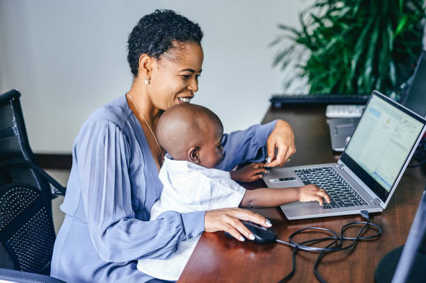 istock Shot of an attractive young mother sitting with her son while using her laptop to work from home 1337239850