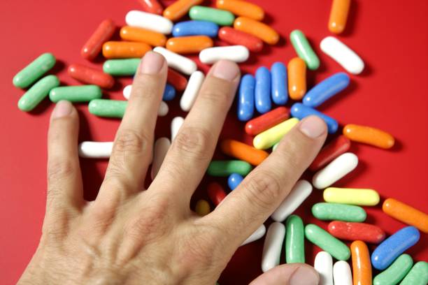istock Human hand holding colorful candy 1337242060