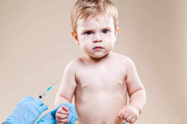 istock Little Caucasian Boy Is beeing Vaccinated with Vaccine. Horizontal Image 1337242115