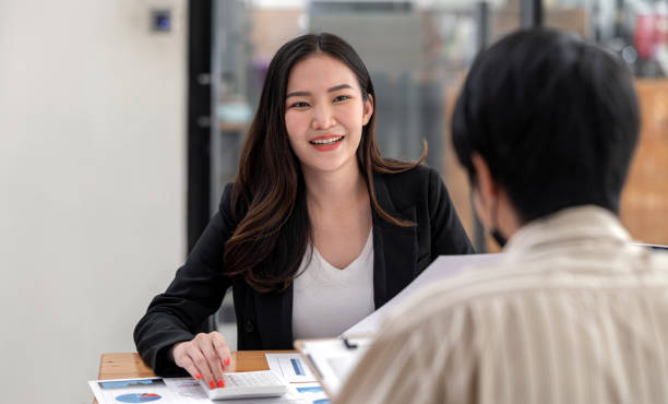 istock Young beautiful businesswoman talking and discussing with her customer while sitting at office desk in office. 1337243422