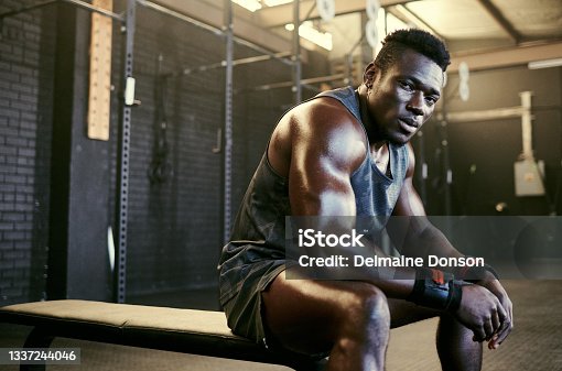 istock Portrait of a young fit sweaty man sitting in the gym after his workout 1337244046