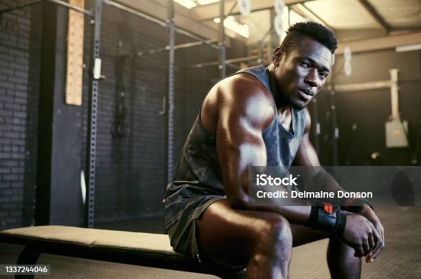 Portrait Of A Young Fit Sweaty Man Sitting In The Gym After His Workout Stock Photo - Download Image Now