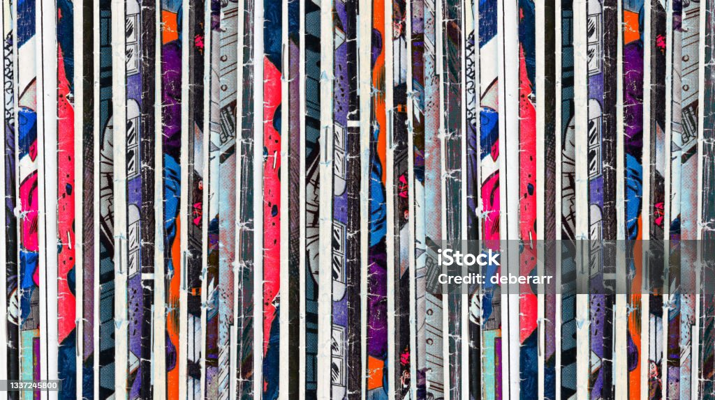 Old comic books stacked in a pile creates colorful paper background pattern of shapes and textures Old comic books stacked in a pile creates colorful paper background pattern of shapes and textures in blue and red Comic Book Stock Photo