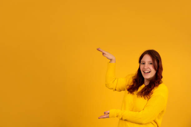istock Young woman showing something with her hands. 1337245802