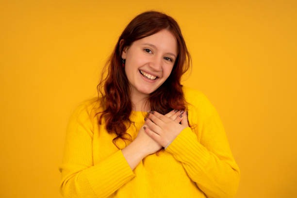 istock Young woman putting hands on her chest expressing gratitude. 1337245808