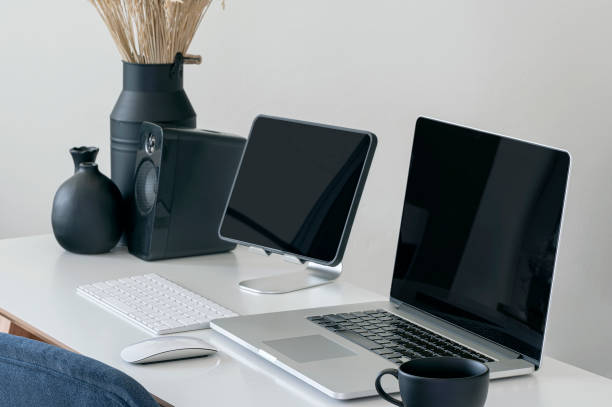 istock Mockup black screen laptop and tablet on white table. 1337246505
