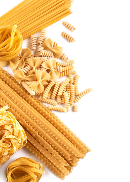 istock Assorted varieties of pasta wallpaper. Mix macaroni, spaghetti on white background with copy space 1337247284