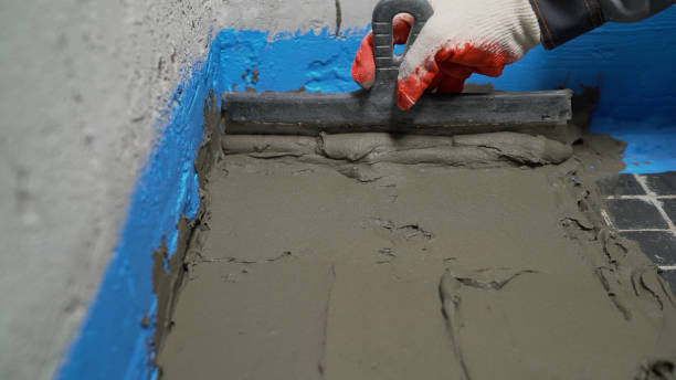 istock Laying ceramic floor tiles, applying an adhesive base. Application of a solution for laying tiles on the floor 1337247457