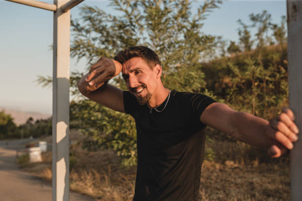 istock Sport men stretching muscle legs after run 1337247902