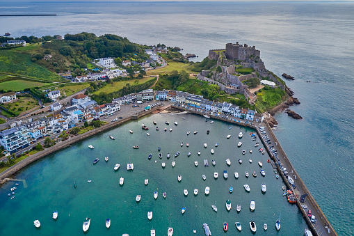 Drone aerial view of Gorey Harbour at high tide. Jersey is a popular holiday/vacation destination as well as an international finance center. Jersey, Channel Islands