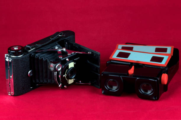 istock Old Film Camera and Old Slide Viewer on a Red Background 1337249342