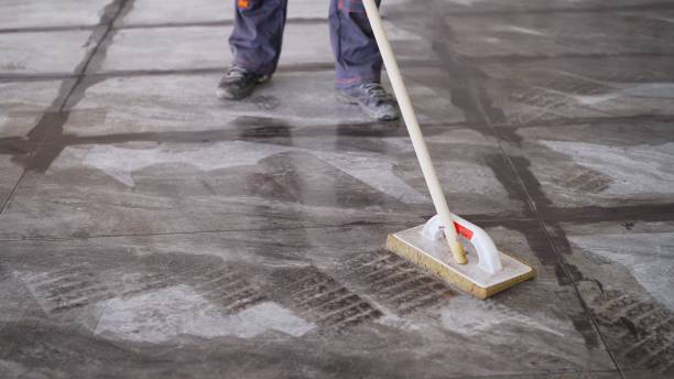 istock Worker washing tiles after work. A worker washes the tiles on the floor after grouting 1337249966