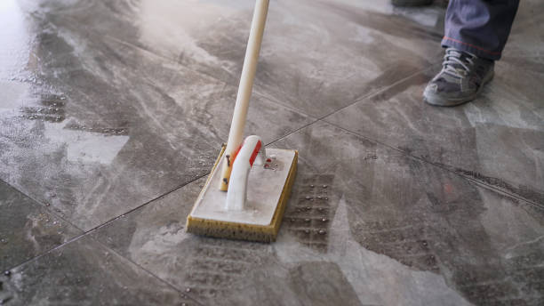 istock Worker washing tiles after work. A worker washes the tiles on the floor after grouting 1337250668