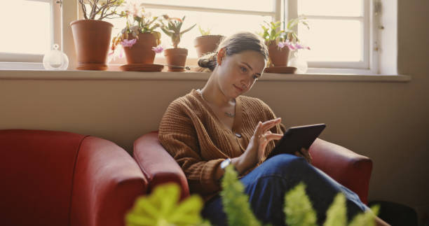 istock Shot of a young woman using a digital tablet at home 1337251209