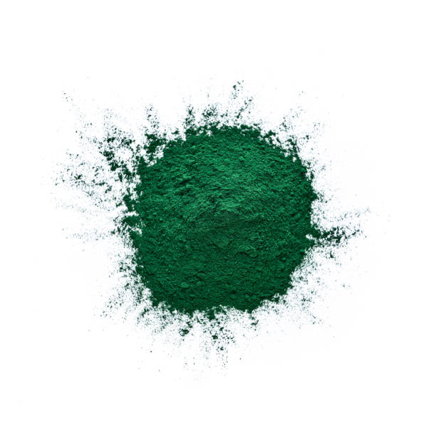 Ground Spirulina heap shot from above on white Overhead view of Spirulina powder heap spilling on white background. High resolution 42Mp studio digital capture taken with Sony A7rII and Sony FE 90mm f2.8 macro G OSS lens spirulina bacterium stock pictures, royalty-free photos & images