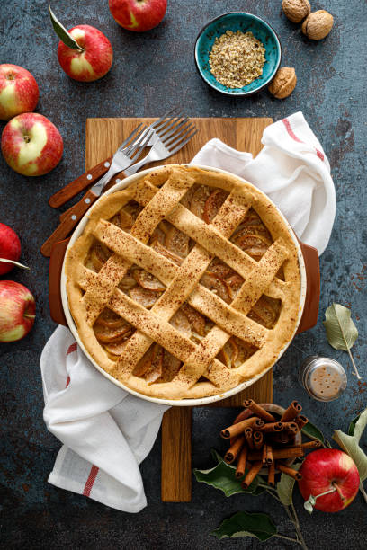 Apple pie with lattice pastry, traditional pastry dessert for Thanksgiving day, autumn baking concept, top view Apple pie with lattice pastry, traditional pastry dessert for Thanksgiving day, autumn baking concept, top view apple pie stock pictures, royalty-free photos & images