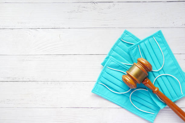 istock top view of gavel and surgical face mask on table 1337253165