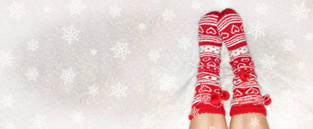 istock Christmas Background, Feet in Christmas Red Socks 1337253189