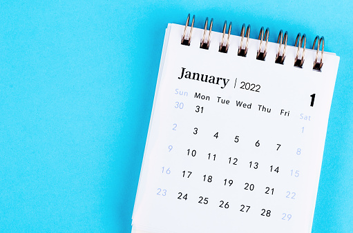 The mini January 2022 desk calendar on blue background.