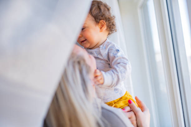 istock Mother embracing her baby boy by the window 1337254676