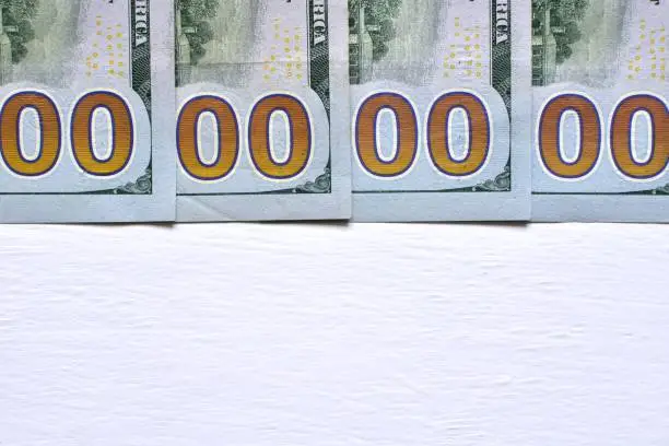 Numbers zero in dollars banknotes on painted white background