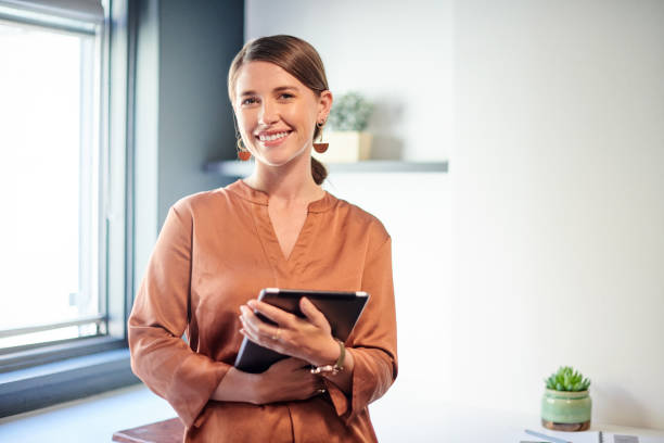 Shot of a young businesswoman using her digital tablet at work stock photo