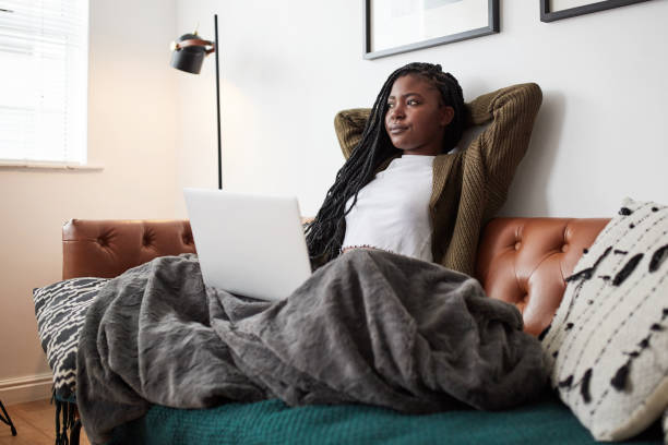 istock Shot of a young woman relaxing while using a laptop at home 1337256862
