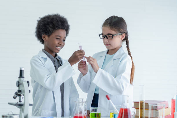 istock Two children scientists making experiments chemical with looking microscope in the laboratory room.
Science and education concept. 1337259251