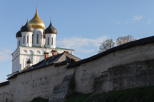 The Trinity Cathedral located since 1589 in Pskov Krom or Kremlin. Ancient Russian Orthodox Church behind old fortification wall