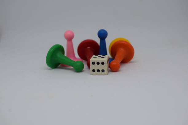 istock chips of different colors and dice for children's board game. 1337260443