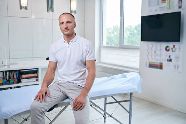 istock Handsome Caucasian chiropractor sitting on massage table in medical office 1337261676